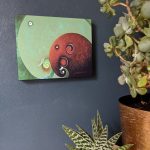 'Moon Gazing' is a mounted art print of an elephant couple in green and brown hues.