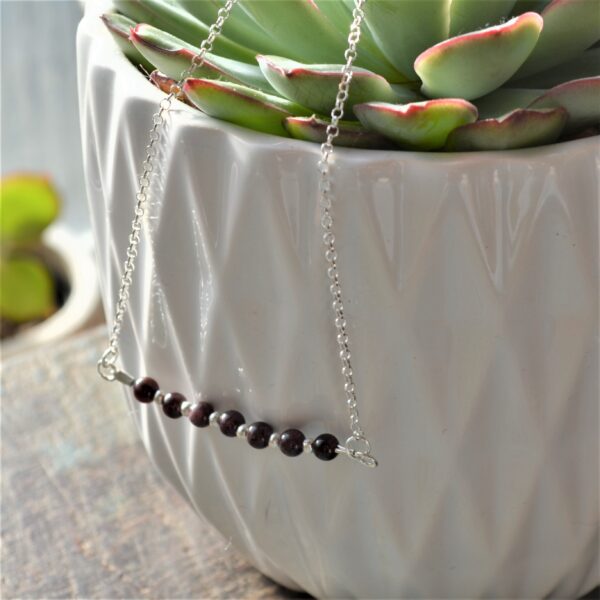 Root Chakra, Garnet Trapeze necklace. Horizontal central bar with red, garnet gemstones and silver beads on a recycled sterling silver chain. Fair Trade, fine silver, handmade