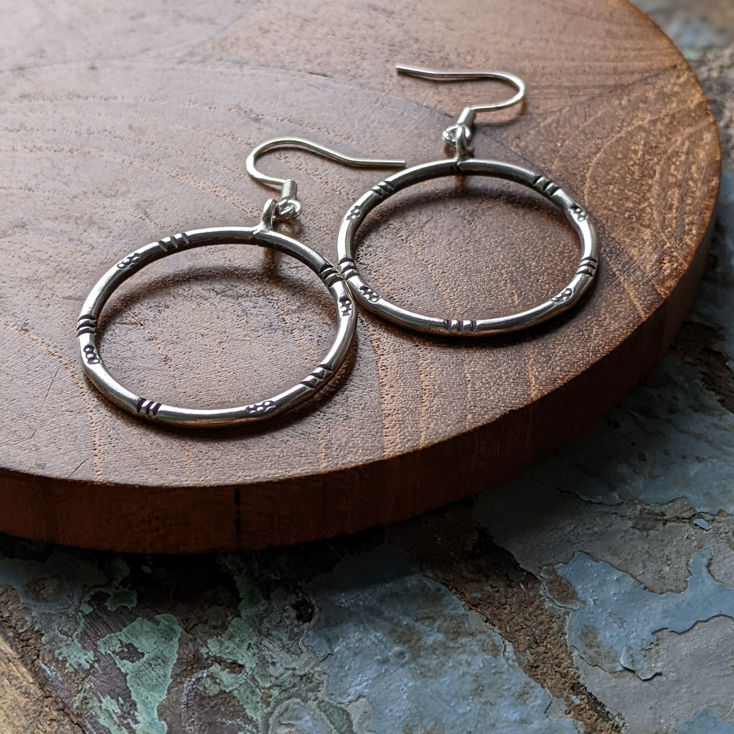 E140 Esther Earrings. Tribal vibe, hoop earrings with oxidised tribal stamping. Fair Trade silver, handmade and unique