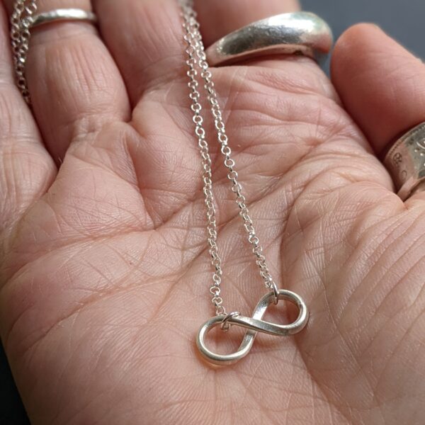 N108 Infinity Necklace. Infinity symbol handcrafted in silver on a belcher chain. The symbol of love, devotion and unity