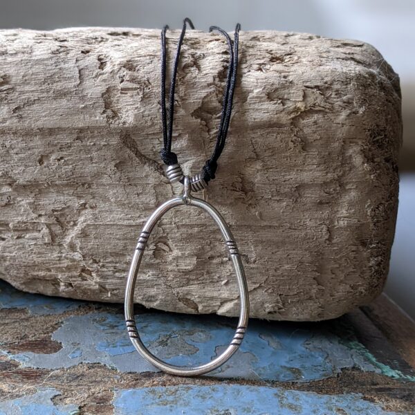 P214 Piper Pendant. Oval statement pendant with tribal stamping and feel. Choose to hand on cord necklace or sterling silver chain. Fair Trade, handmade, fine silver