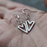 E134 Lumo Heart Earrings. Asymmetrical open heart shaped earrings. Small dangle drop, handmade, fine silver, fair trade.