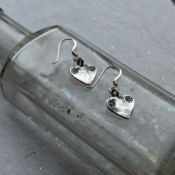 E090 Margo Heart Earrings. Heart shaped dangle drop earrings, handcrafted in recycled fine silver. Fair Trade