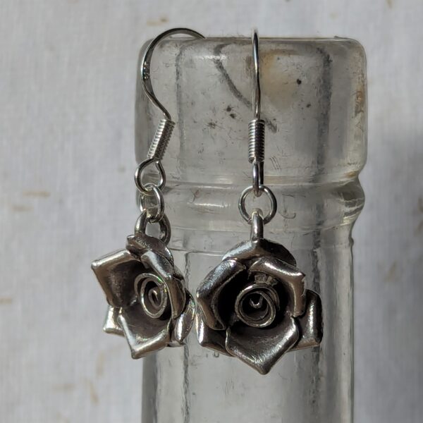 E193 Talia Rose Earrings. Rose shaped dangle drop earrings, created from recycled fine silver. Ethically created and Fair Trade.