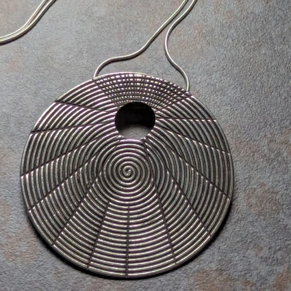 HL752 Juno Pendant Necklace. Statement necklace with a fine silver disc pendant with oxidised spiral patterning. Fair Trade, ethically made.