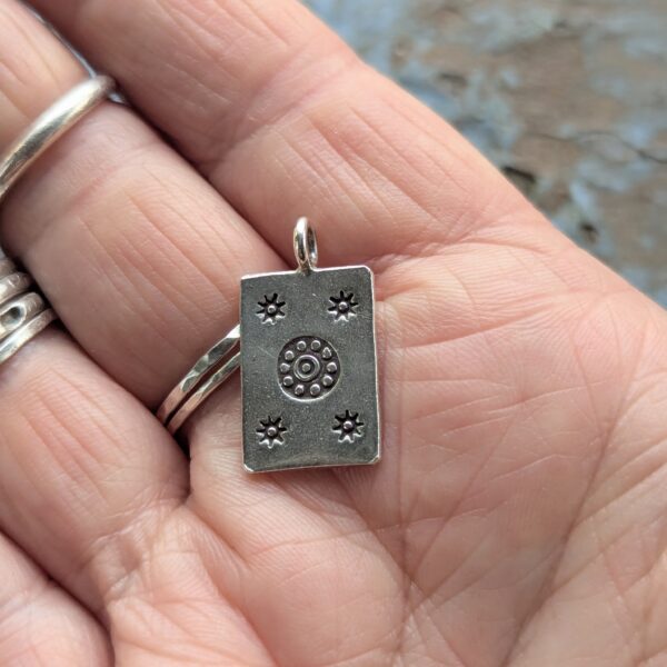 P044 Josie Pendant. Rectangular pendant with oxidised star and flower stamping. Ethically handmade from recycled fine silver. Fair Trade. A choice of necklaces is available.