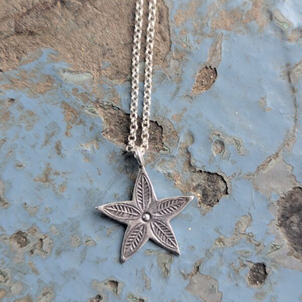 P078 Hoshi Star Pendant. Star shaped pendant with oxidised stamped detailing. Fair Trade, recycled fine silver. Ethically handcrafted. A choice of necklaces are available