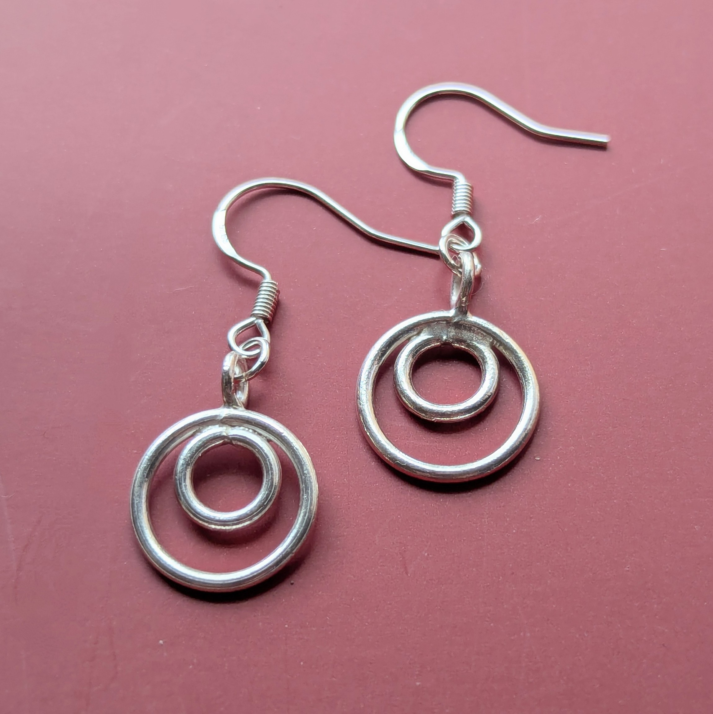 E206 Tamara Earrings. Double hoop dangle drops. Handmade from recycled fine silver and Fair Trade.