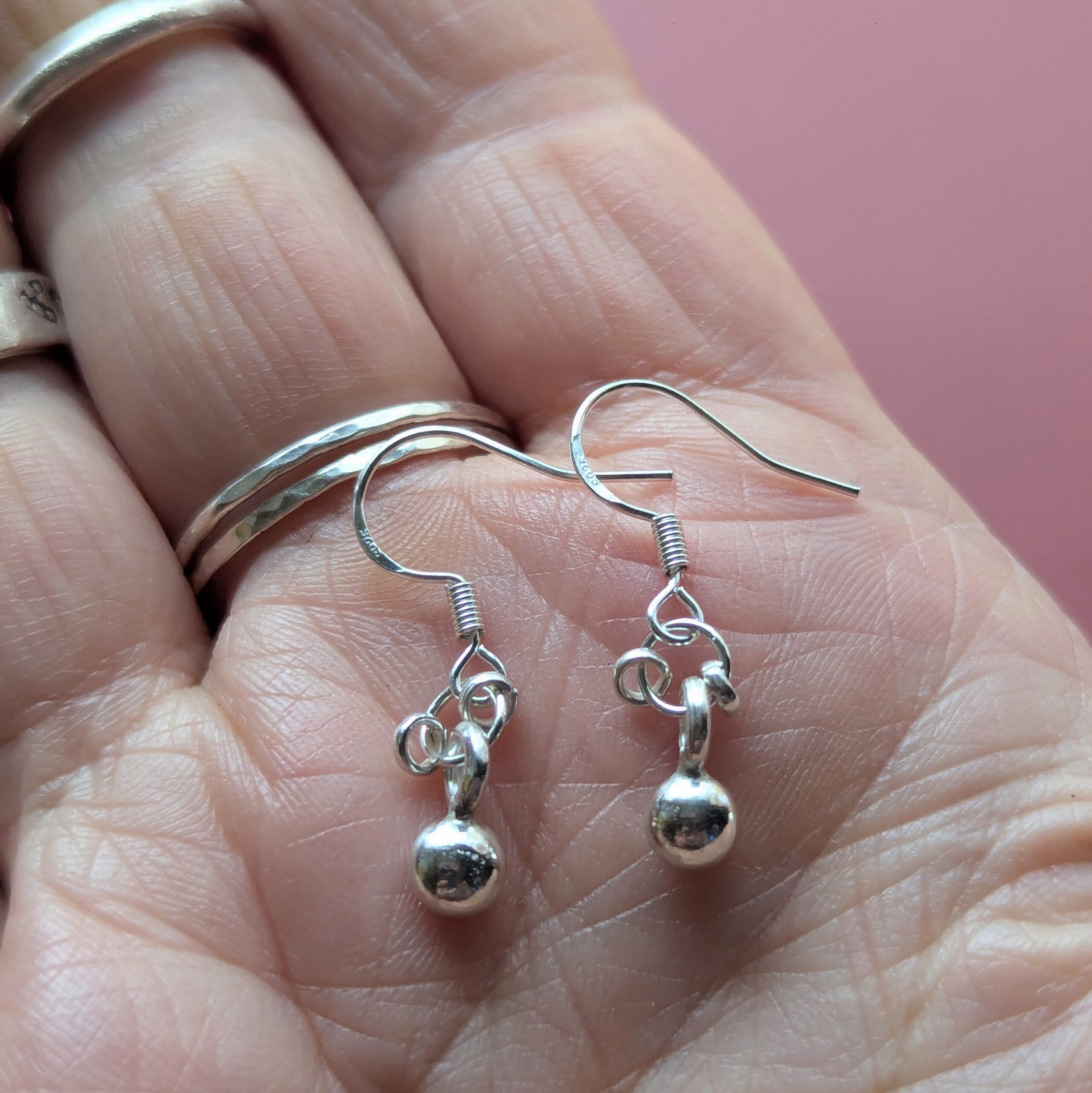 E207 Adriana Earrings. Tiny dangle drop ball earrings. Spiral dangle drops. Handmade from recycled fine silver and Fair Trade.