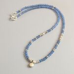 N125 Doris Gem and Charm Necklace - Blue Aventurine. Faceted gemstone beads with Fair Trade silver beads and a central silver charm detail. Clasp sterling silver.