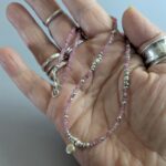 N125 Doris Gem and Charm Necklace - Tourmaline. Faceted gemstone beads with Fair Trade silver beads and a central silver charm detail. Clasp sterling silver.