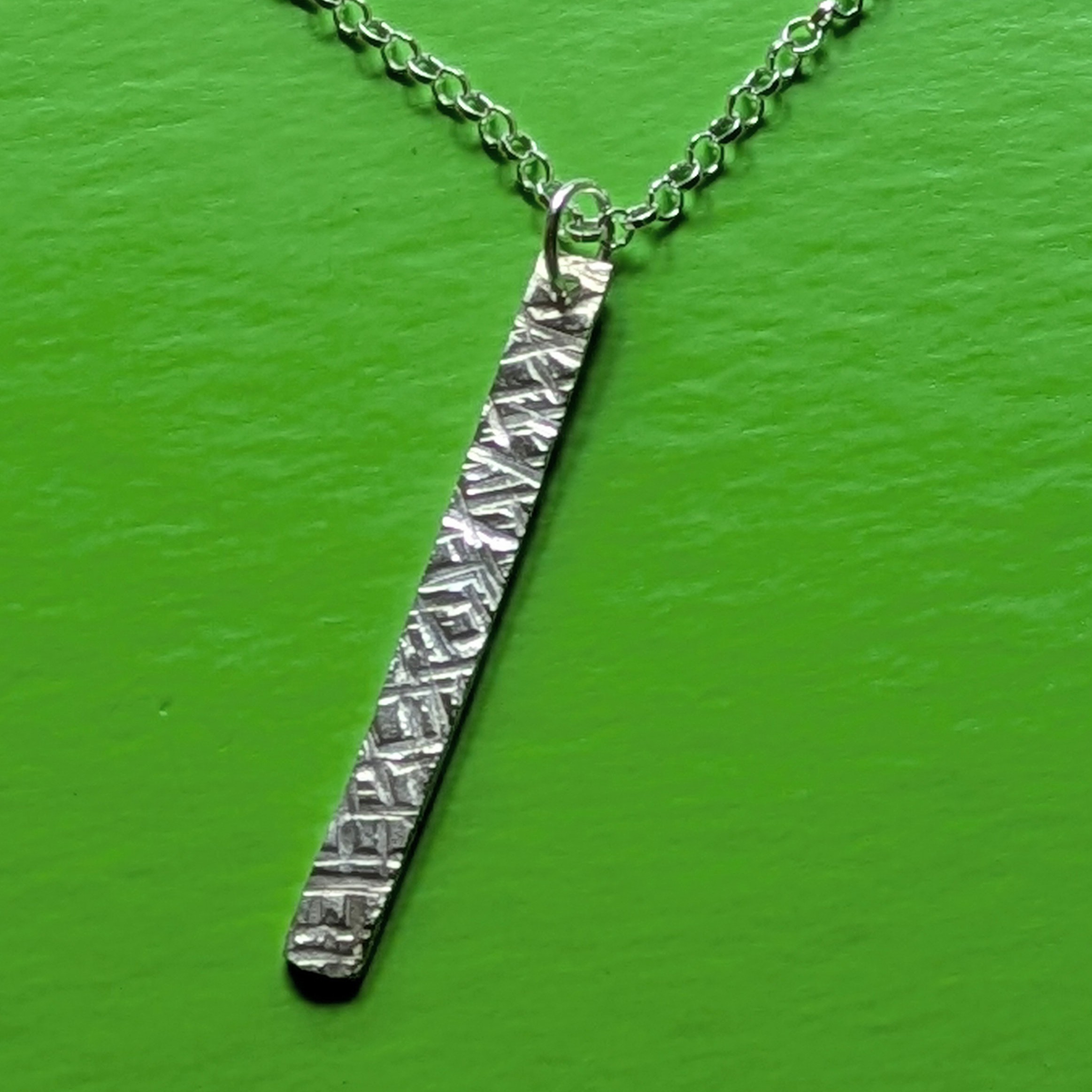 N130 Bronte Necklace. Elegant pendant drop necklace with a textured surface to play with the light whilst worn. Hand made in Cheshire, UK from recycled silver.