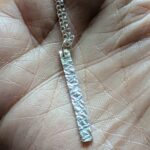 N130 Bronte Necklace. Elegant pendant drop necklace with a textured surface to play with the light whilst worn. Hand made in Cheshire, UK from recycled silver.