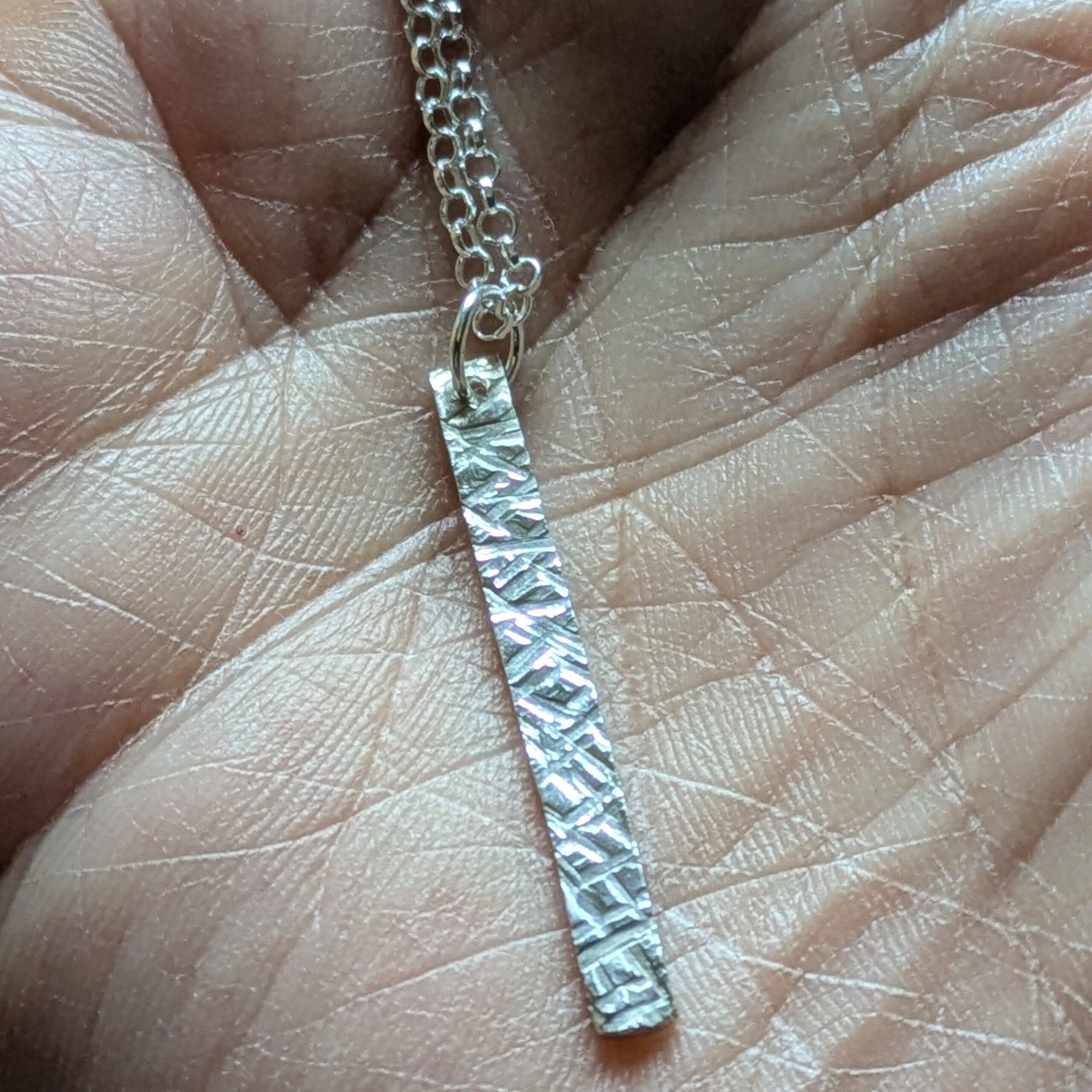 N130 Bronte Necklace. Elegant pendant drop necklace with a textured surface to play with the light whilst worn. Hand made in Cheshire, UK from recycled silver.