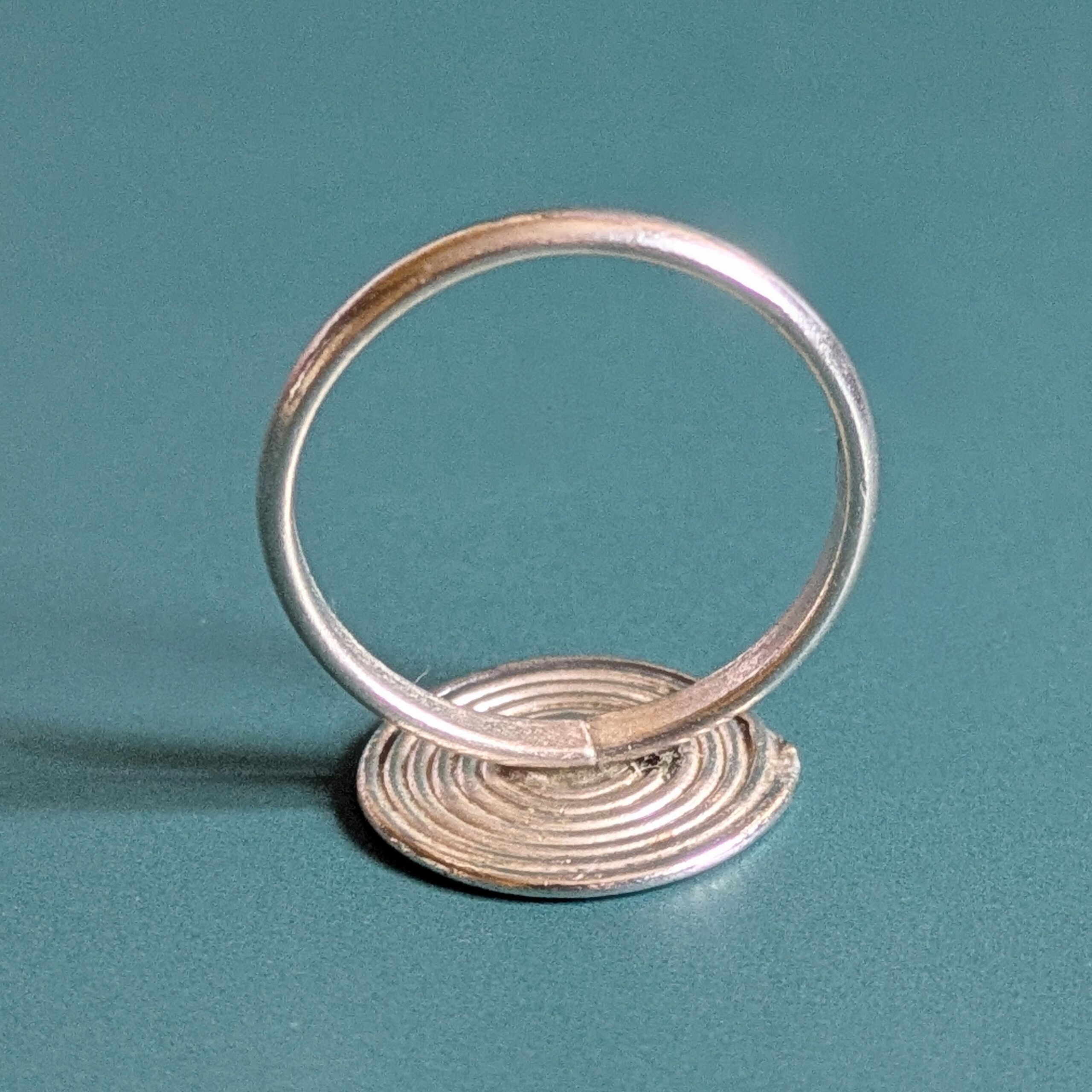 R069 Rune Ring. A statement spiral disc ring. Handcrafted from recycled fine silver. Fair Trade.