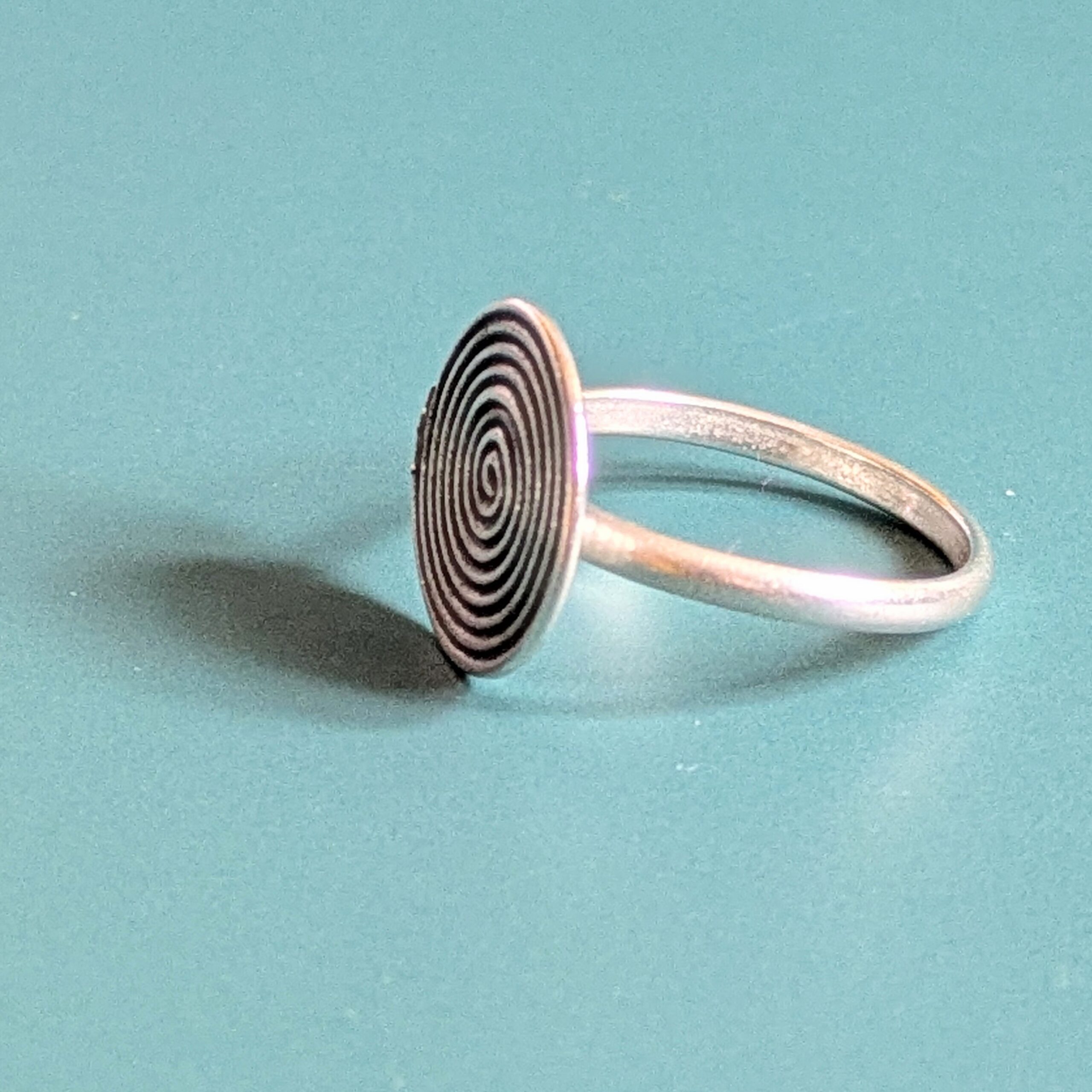 R069 Rune Ring. A statement spiral disc ring. Handcrafted from recycled fine silver. Fair Trade.