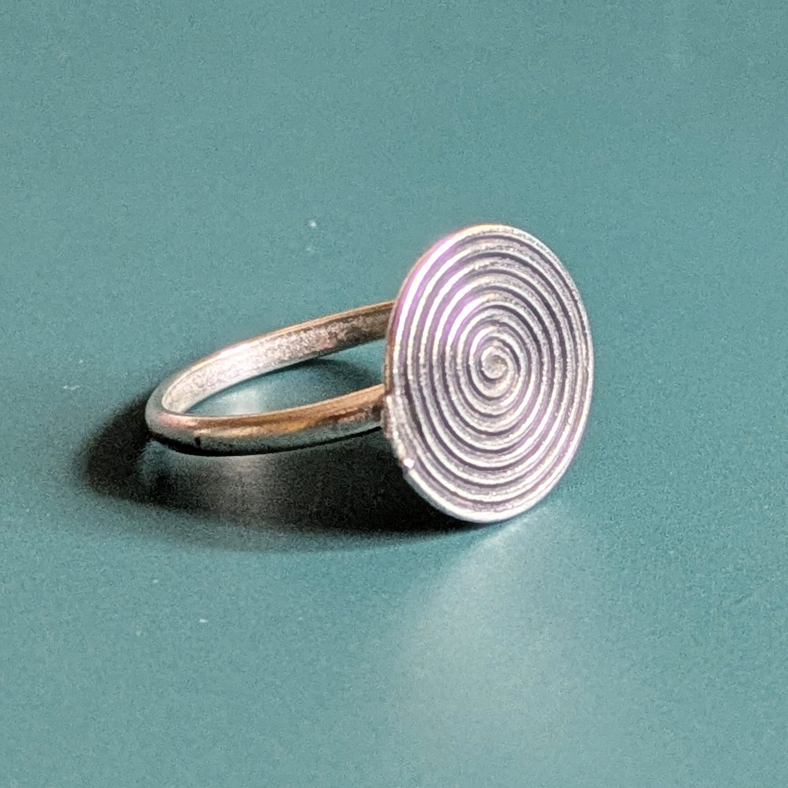 R069 Rune Ring. A statement spiral disc ring. Handcrafted from recycled fine silver. Fair Trade.