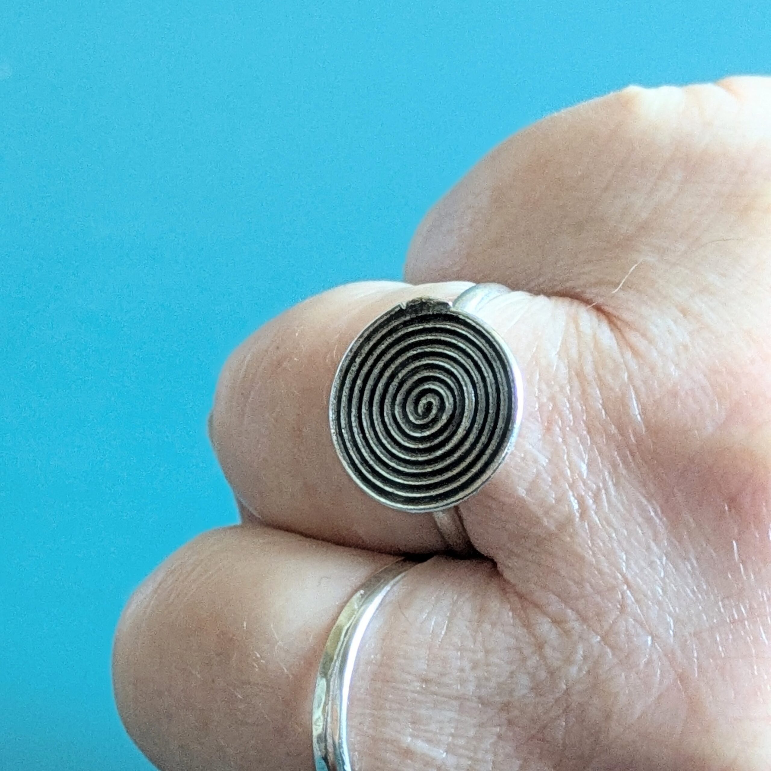 R069 Rune Ring. A statement spiral disc ring. Handcrafted from recycled fine silver. Fair Trade.