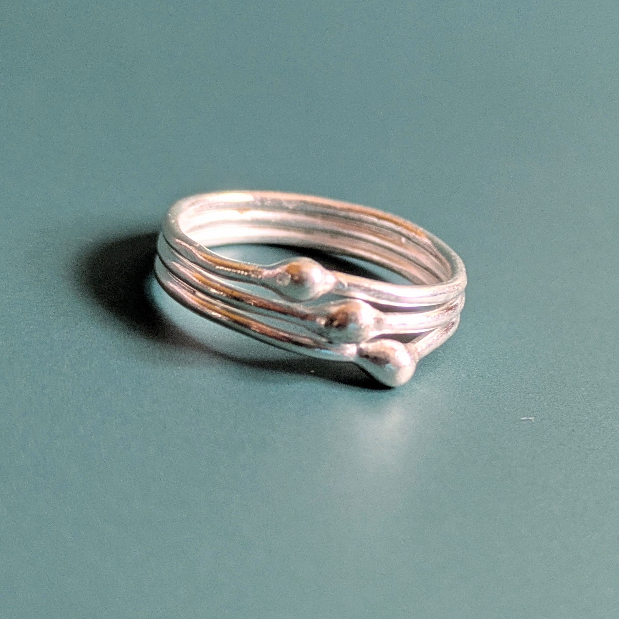 R071 Robbie Ring. A triple band ring with central detailing. Fine silver. Fair Trade