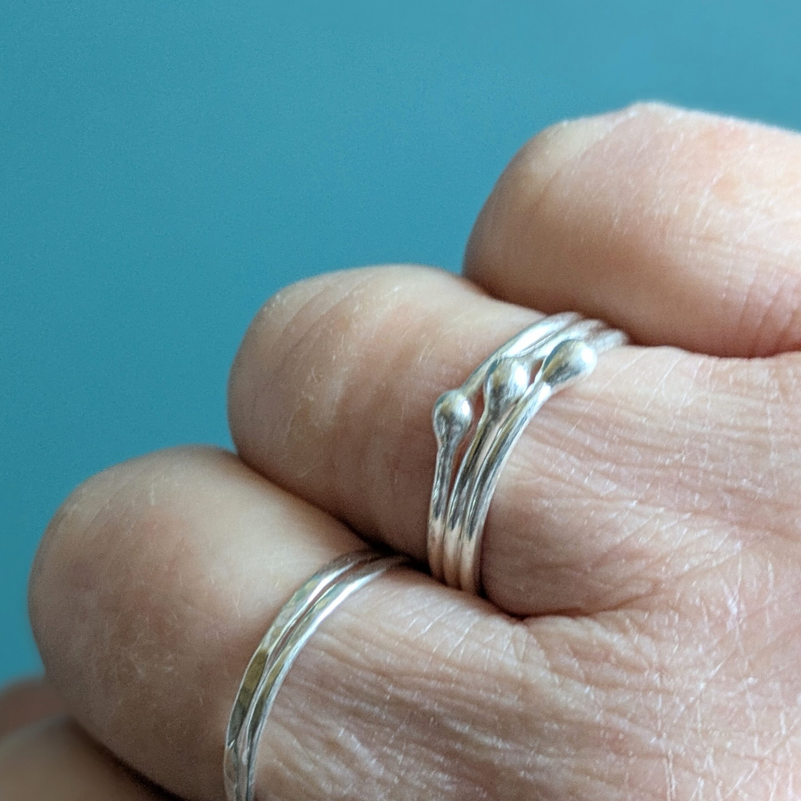 R071 Robbie Ring. A triple band ring with central detailing. Fine silver. Fair Trade